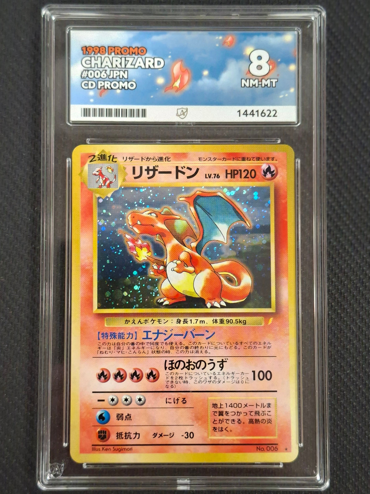 A graded 1998 Pokémon Charizard CD promo trading card, encapsulated in a clear plastic slab. The card features Japanese text and artwork, with a yellow border and a red-orange Charizard illustration.