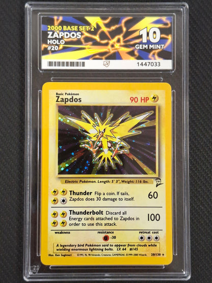 A graded Pokémon trading card of Zapdos, a 2000 Base Set. The card is Ace graded 10 displayed against a dark textured background.